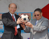 Ambassador presenting a soccer ball to NTU